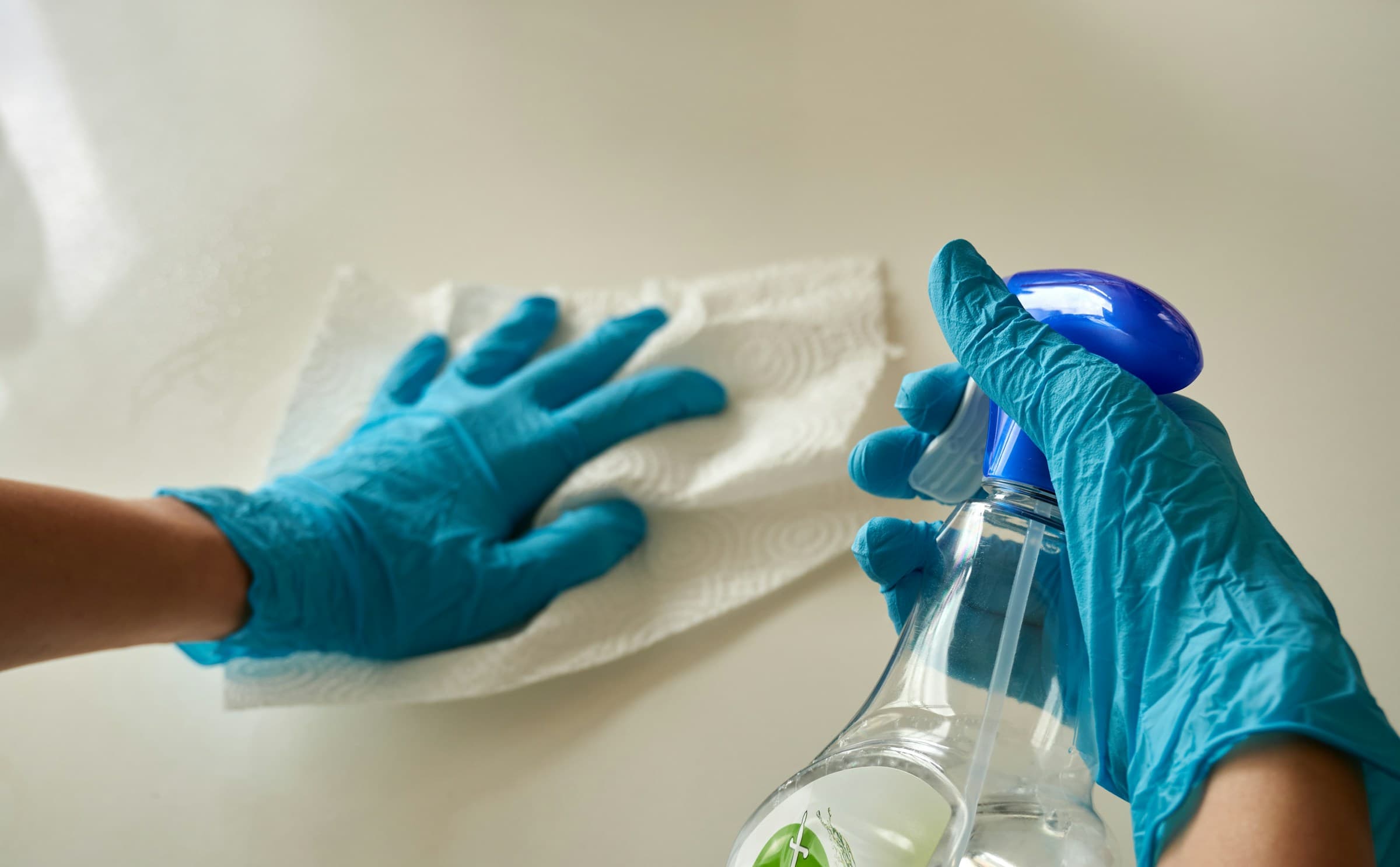 A blue cleaning cloth and spray bottle, ready for detail work.